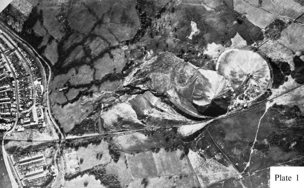 Historical aerial photograph showing Aberfan village below the colliery spoil tips before the 1966 disaster.
